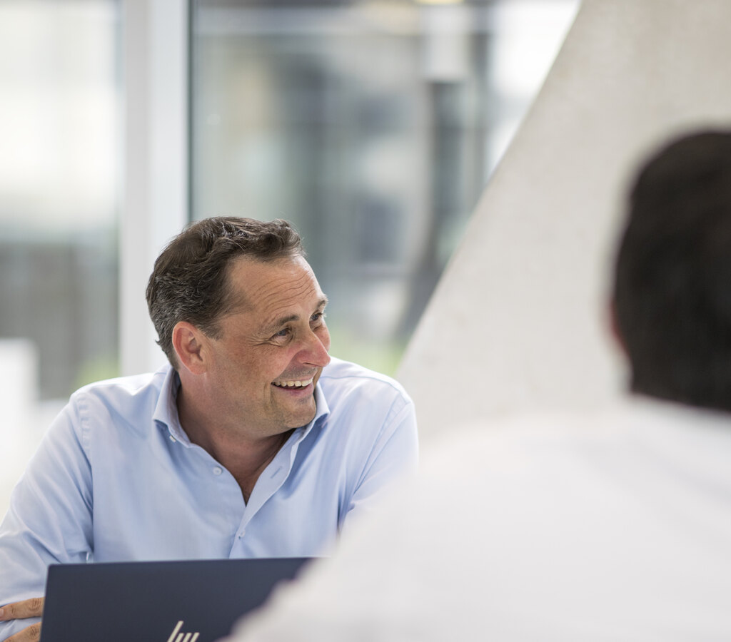 A We Can consultant discussing AI workflows with a client