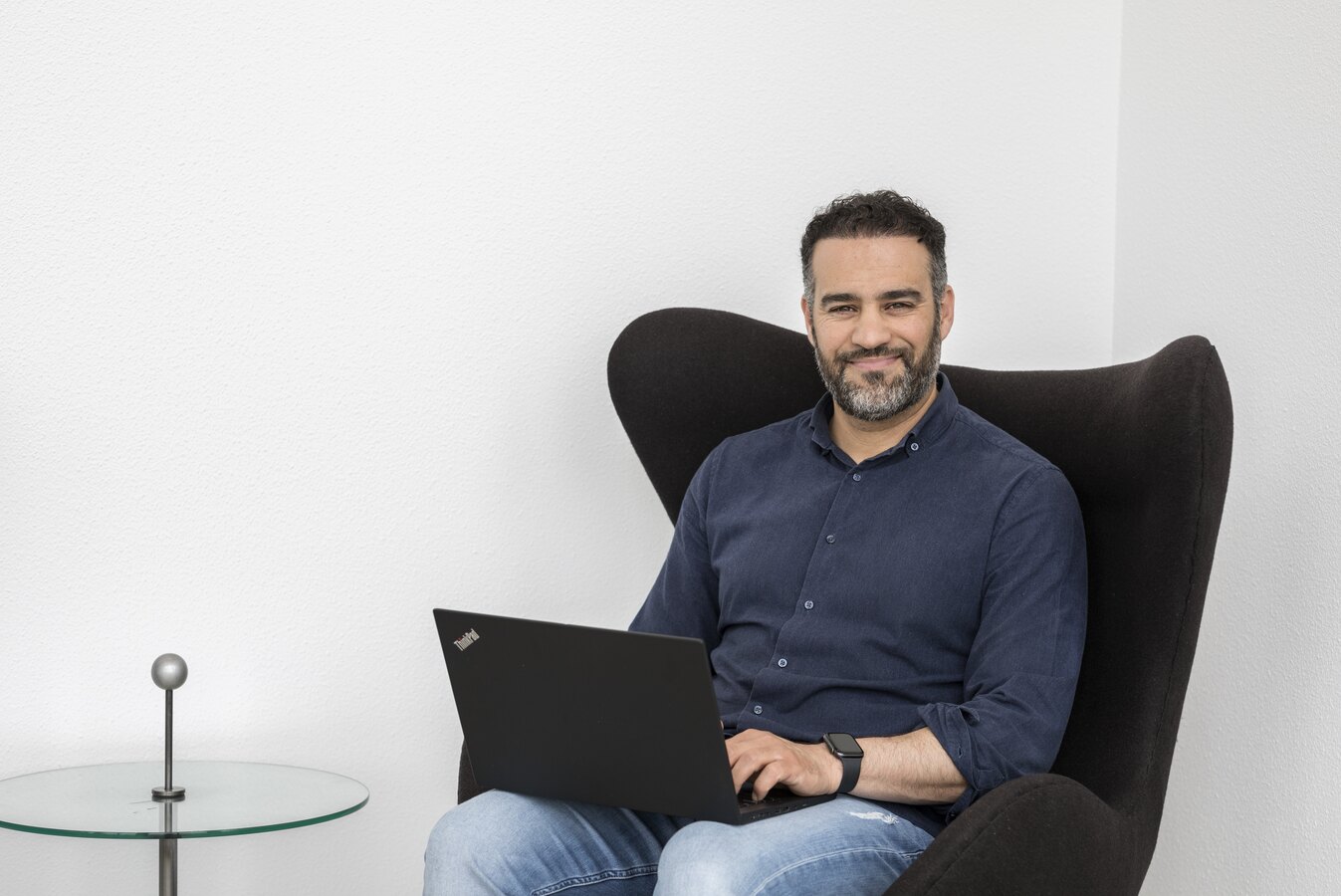 A We Can consultant working on product data from a laptop